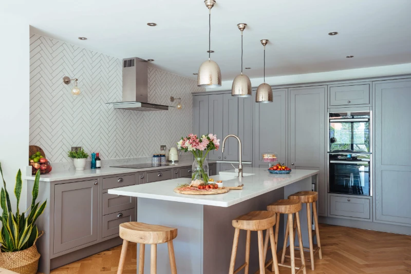 Beautiful Traditional kitchen with hangling lights over kitchen island with stools